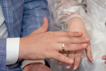 Hands. Newlyweds exchange wedding rings