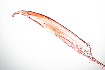 splash of red wine isolated on white background flying