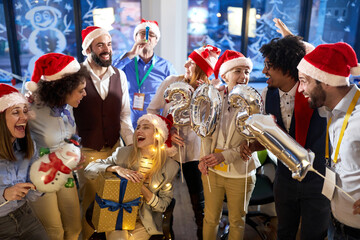 Group of happy colleagues posing for a photo at New Year eve company party. New Year, holiday, party, people concept