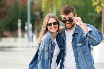 Young couple with stylish sunglasses outdoors