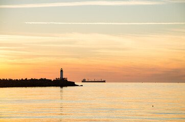 sunset lighthouse boat sea