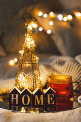 Christmas background with cup of tea in the living room. Winter concept of a cozy home