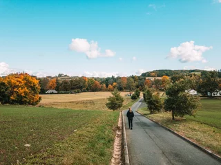 woman taking an autumn walk around the village © Ondrej Hlavin