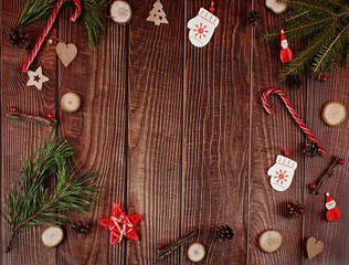 Wooden christmas abstract background with fir tree, cones, candy canes and natural decor. New year concept