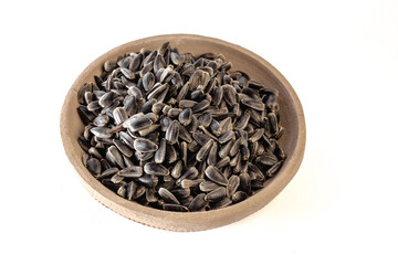 Sunflower seeds in a plate on a white background