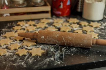 little girl bakes cookies in the form of stars. Christmas cookies.
