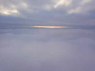 High aerial flight between fog and clouds.