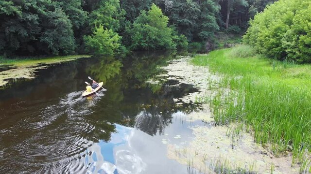 Aerial drone view of sport canoe on summer calm forest river. Sport, recreation, healthy lifestyle, isolation concept.