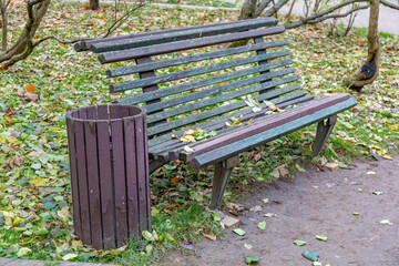 A recreation bench made of wood in a city park in autumn