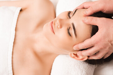 Obraz na płótnie Canvas Thai head Massage therapy. Mixed race woman enjoys massage at spa. Antistress procedures at wellness salon