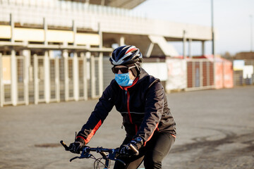 cyclist during quarantine rides a bicycle in a mask