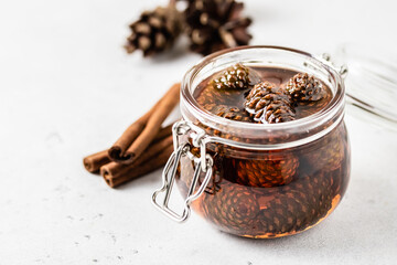 Homemade pine cone jam in a jar. Space for text.