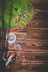 Fishing tackle on a wooden background. Studio photo.