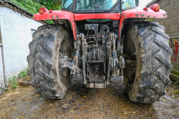 The back end of a tractor showing the power take of point and 3 point linkage, - 393906522