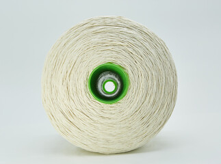 A large spool of white cotton thick thread or rope. Use in food production or packaging. Industrial use