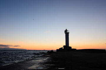 Fototapeta premium lighthouse on the beach in a sunset