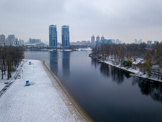 Obraz premium Aerial drone view. Snow-covered city beach in the Kiev. A thin layer of the first snow on the sand.