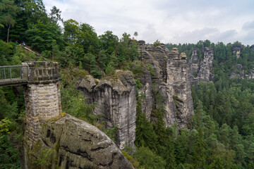 Fototapeta na wymiar Bastei is a sandstone formation with an observation deck in Saxon Switzerland on the right bank of the Elbe River between the resort of Rathen and the city of Velen