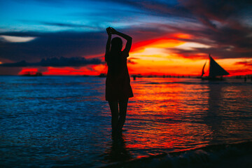 Young fashion woman in green dress on the beach