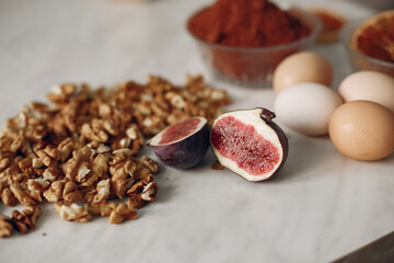 Nuts and figs lie on the table. Cocoa in a small bowl.