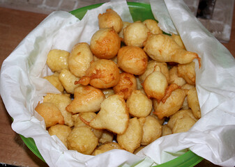 Pettole or pittule. Bullets of very soft leavened dough fried in boiling oil, typical of the...