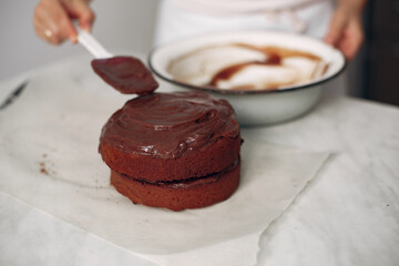 Lady is preparing dessert.Woman bakes a cake.