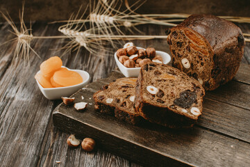 bread with dried fruits, nuts and dried apricots on a wooden Board 