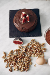 Chef in white clothes prepares a chocolate cake. Lady is preparing dessert. Woman bakes a cake.
