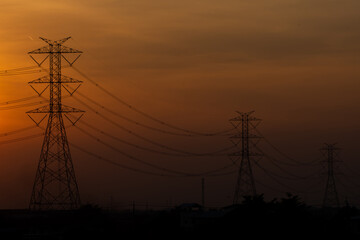 High voltage poles and the light from the evening sun