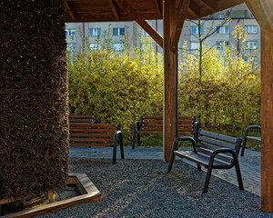 Empty benches in front of brine graduation tower in city park.