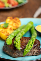 asparagus with potatoes and a steak