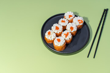 Sushi set on green background with chopsticks
