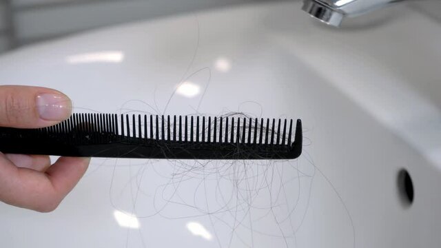 Hair left on the comb after brushing the hair. Hair loss problem