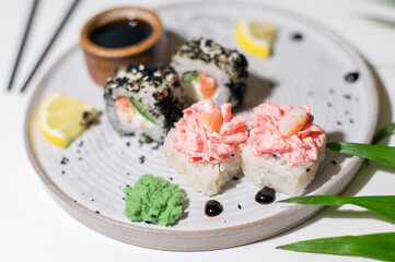 Sushi rolls on light background with leafs