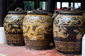 Thailand traditional water jars used for drinking water storage with wooden lids and handles