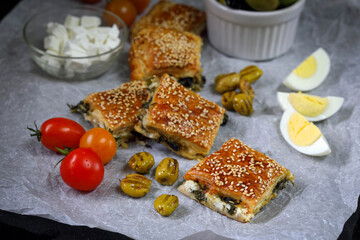 Burekas. Puff pastry pies with spinach with spinach, salted cheese, and sesame