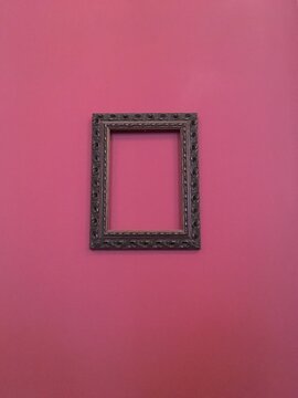 Picture Frame Hanging On Pink Wall
