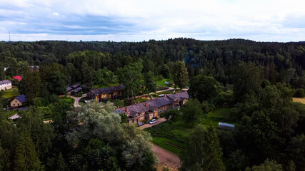 Fototapeta na wymiar Old Wooden Houses Built for Paper Mill Workers in Ligatne. Wooden Row House Aerial Dron Shot
