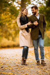 Young couple walking in the autumn park