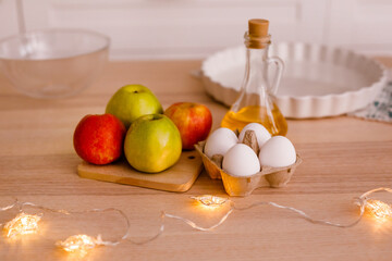 Ingredients for traditional apple pie: apples, eggs, butter, sugar, cinnamon and flour. New Year's Eve concept