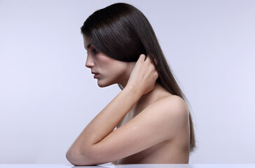 Obraz premium Beauty portrait of a young girl in profile on a light background