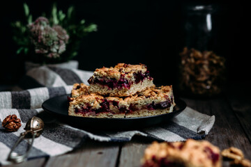shortcrust pastry pie with black currants and tea on a dark background