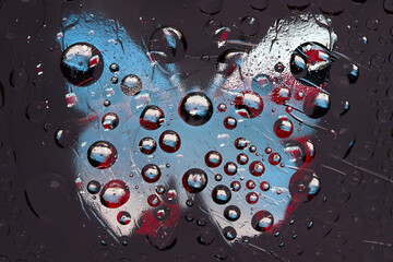 Multi colored spheres are located against the anthracite background with red-white-blue silhouette of a butterfly. Abstract fantasy. 