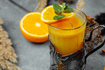 Cocktail Trans-Siberian Express. Cocktail with brandy, orange juice, sea-buckthorn puree, ginger and pomegranate. Warming winter cocktail. Cocktail for Christmas and New Years