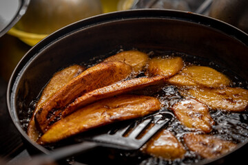 A close up shot of plantain being fried in oil 