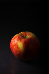 An apple against black background