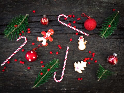 Flat Lay Of Red And White Christmas Decorations Consisting Of Candy Canes,gingerbread,red Ribbon