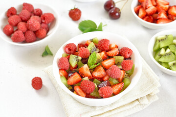 Healthy breakfast with fruit salad from strawberry, kiwi and raspberry