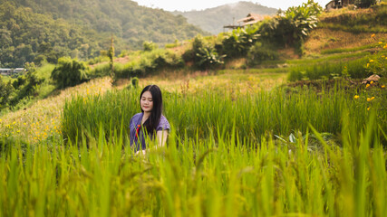 Asian woman smile and stand on  Rice terraces in Pa Bong Piang , Chiang Mai , Thailand.