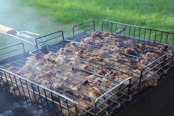 Cooking barbecue chicken on the grill. Close-up.